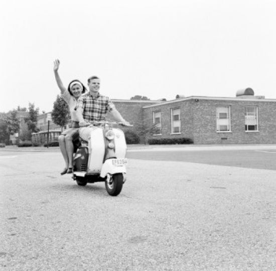 Young happy couple riding scooter poster print