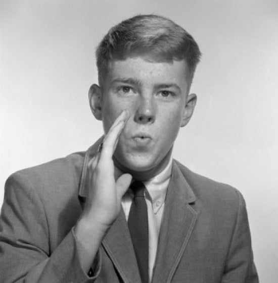 Teenage Boy Whispering Poster Print in studio shot