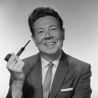 Mature man holding a pipe and smiling poster print