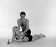Young man applying suntan lotion on young woman's back poster print.