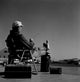 Fisherman Sitting in Chair at the Edge of Water Poster Print