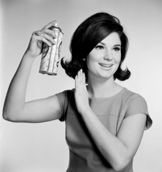 Young woman using hairspray poster print showcasing beauty and style
