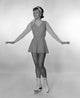 Studio portrait of young woman ice skating, vibrant colors and dynamic composition.