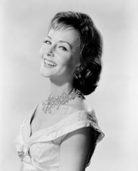 Studio Portrait of Young Woman Smiling Poster Print showcasing a joyful expression.