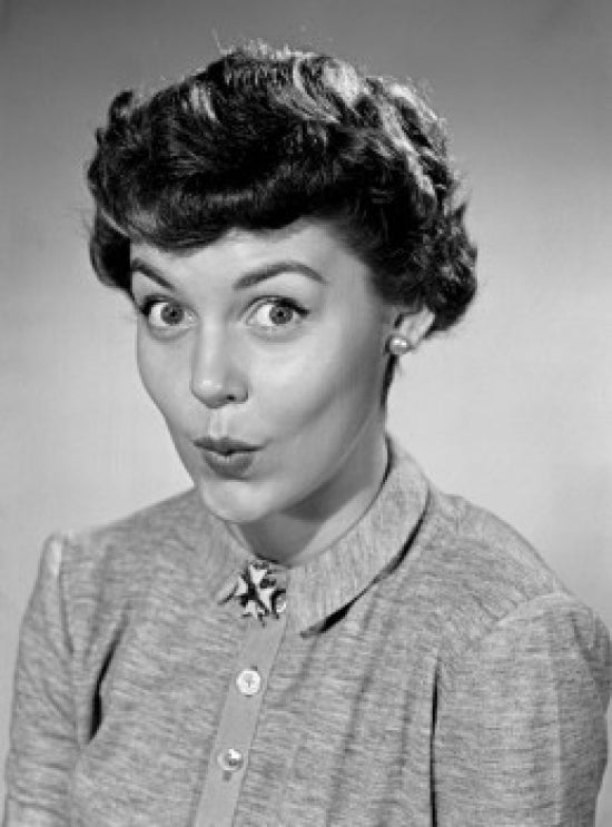 Young female flight attendant smiling at airplane door poster print.