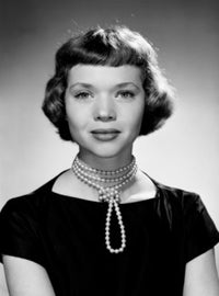 Elegant portrait of a young woman wearing a pearl necklace.