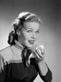Mid adult woman sneezing while holding a tissue poster print.