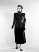 Mid adult woman wearing skirt, jacket, and hat poster print.
