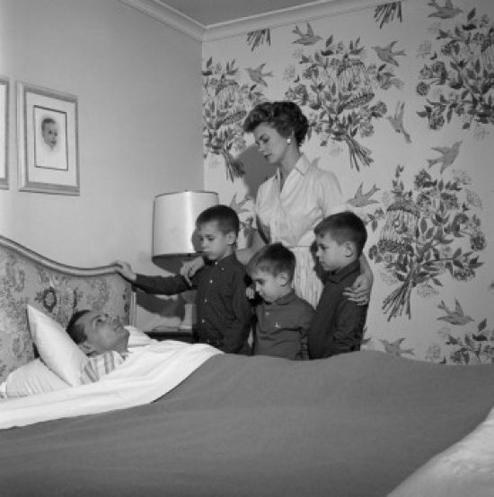Family Around Ill Father's Bed Poster Print depicting family unity and love.