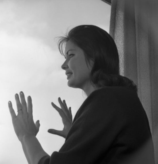 Woman Looking Through Window Poster Print