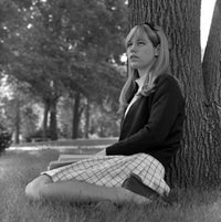 Student Girl Sitting Under Tree Poster Print showcasing a serene scene.