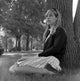 Student Girl Sitting Under Tree Poster Print showcasing a serene scene.