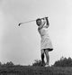 Woman Playing Golf Poster Print showcasing a woman in action on the golf course.