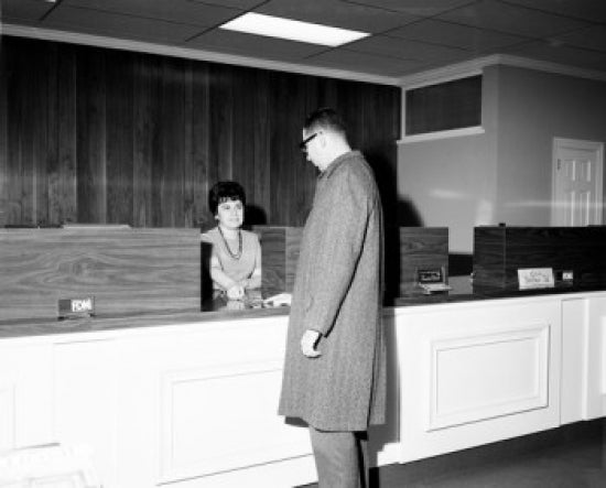 Man at Hotel Reception Desk Poster Print showcasing elegance and hospitality.