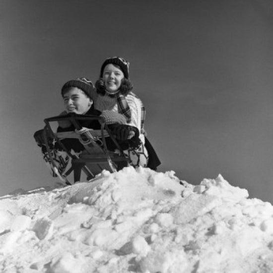 Children on Sledge Poster Print depicting joyful winter fun.