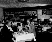 Couple Dining in Restaurant Poster Print showcasing an intimate moment.
