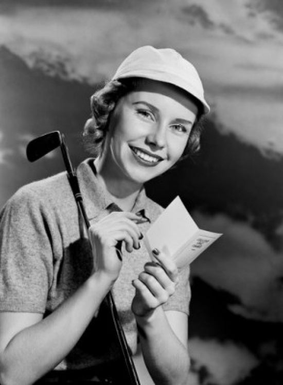 Smiling woman holding golf club poster print