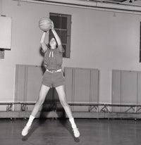 Dynamic Girl Jumping with Basketball Poster Print on premium paper.