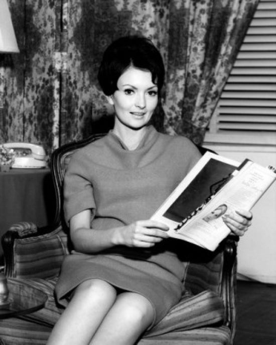 Portrait of a Mid Adult Woman in an Armchair Reading a Magazine Poster Print
