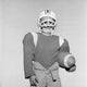 Boy wearing football helmet and holding football poster print