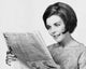 Close-Up of a Young Woman Reading a Newspaper Poster Print
