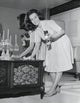 Portrait of a Young Woman Polishing Furniture Poster Print