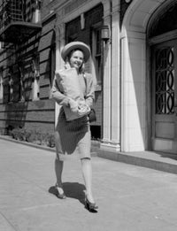 Young woman carrying groceries in city poster print