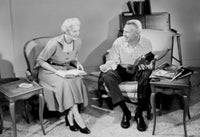 Senior Couple Relaxing in Living Room Poster Print