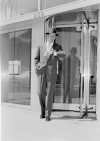 Businessman looking at wristwatch poster print