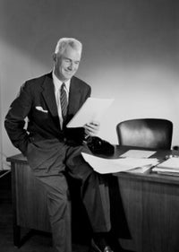Senior businessman reading in his office poster print.