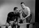 Two football players getting dressed poster print.