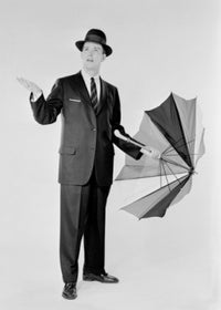Man in suit holding an umbrella against a rainy backdrop poster print.
