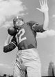 Low angle view poster print of an American football player in action.