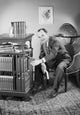 Man reaching for a book in a cozy room poster print.