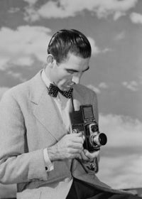 Man Using Camera Poster Print showcasing the art of photography.