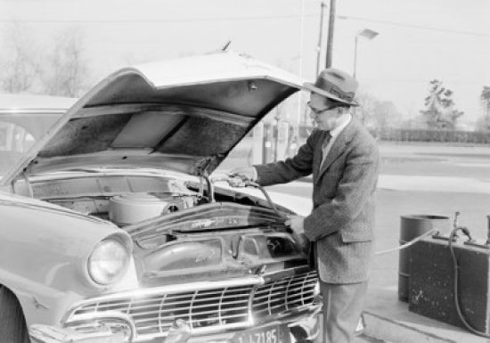 Man pouring water into car radiator poster print.