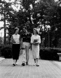Three young students walking and talking poster print