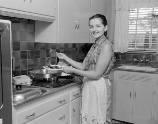 Woman holding plate with food in the kitchen, poster print.