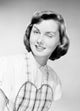 Portrait of Young Housewife Winking Poster Print showcasing a playful young woman.