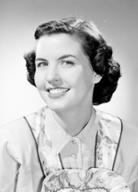 Studio portrait of a young woman smiling poster print.