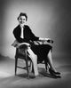 Portrait of a Young Woman Sitting in a Chair Smiling Poster Print