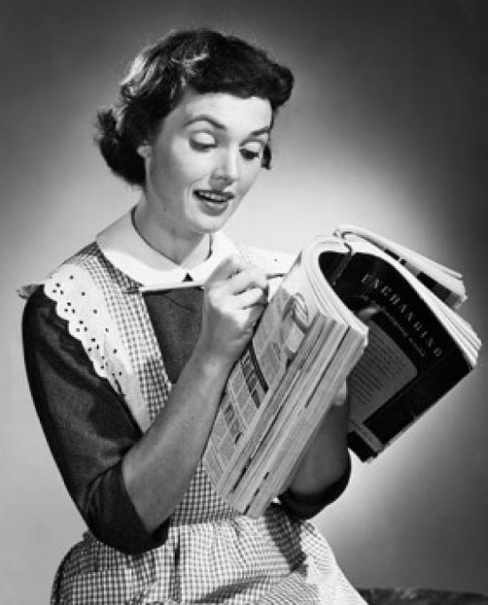 Close-up of a young woman writing on a catalogue, poster print.