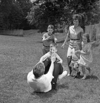 Family Playing in the Backyard Poster Print featuring children playing outdoors.