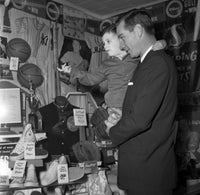 Father and Son Watching Shoes in Store Poster Print, heartwarming family moment
