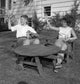 Young couple waving at outdoor table poster print