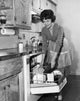 Young woman working in a kitchen, poster print