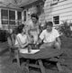 Family bonding moment poster print featuring a mature woman with her adult son and daughter in a backyard.