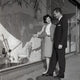 Mid adult couple admiring a window display poster print.
