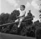 Colorful poster print of a boy sitting on a seesaw and shouting.
