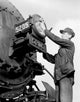 Male Worker Cleaning Train Headlight Poster Print showcasing vintage industry theme.